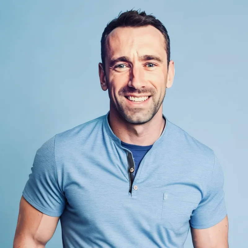 Dr. Grant Radermacher smiling in a light blue short-sleeve shirt